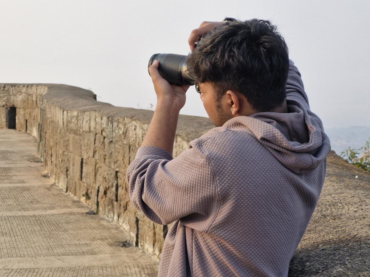Nihar photographing the landscape with a camera